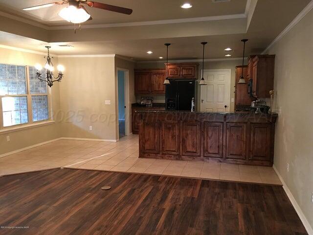 6911 Nick Street Amarillo, TX 79119 - Photo 3 of 6 a view of entryway with wooden floor