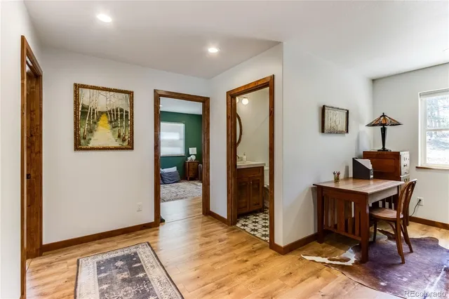 a view of a workspace with furniture and a window
