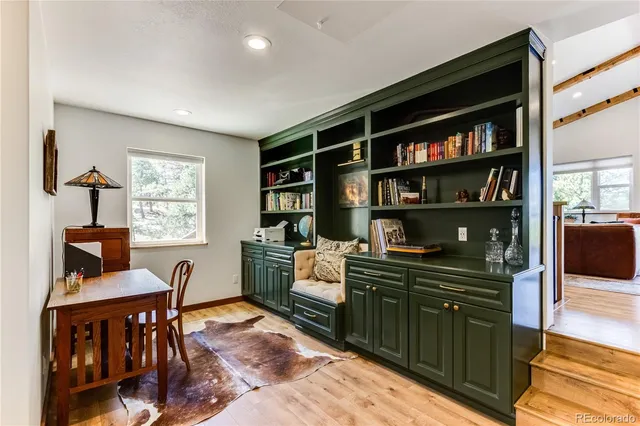 a kitchen with a table chairs refrigerator and a sink