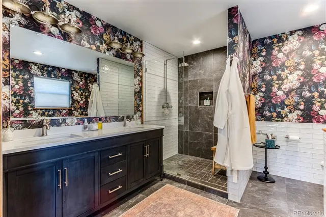 a bathroom with a double vanity sink mirror and shower
