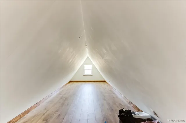 a backyard of a house with wooden floor barbeque oven and outdoor seating