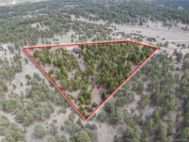 a aerial view of a house with a yard