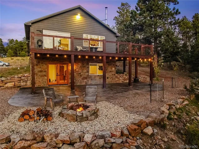 a backyard of a house with table and chairs