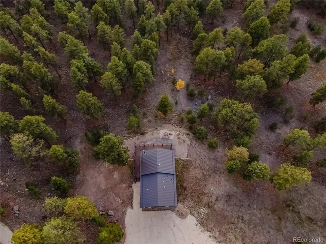 an aerial view of a house with yard and sitting area