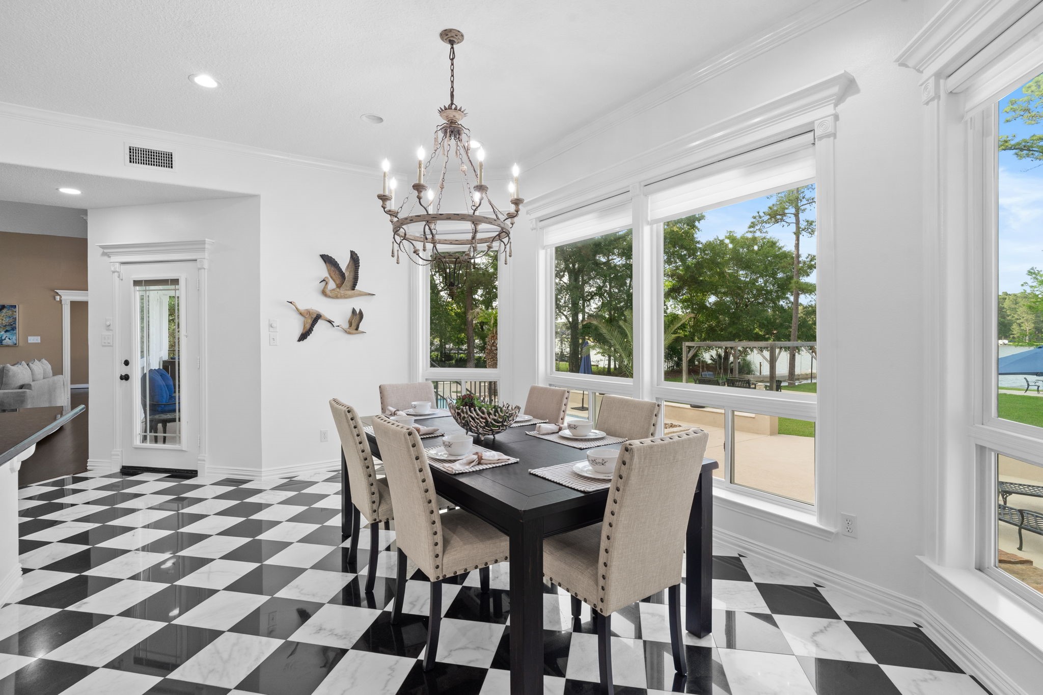 20002 Indigo Lake Drive Magnolia, TX 77355 - Photo 11 of 50 a view of a dining room with furniture a chandelier and wooden floor