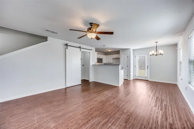 a view of a kitchen with a dishwasher and wooden floor