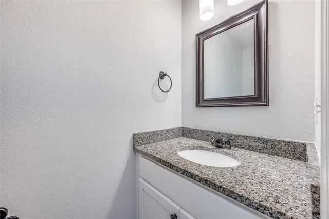 a kitchen with granite countertop a sink and cabinets