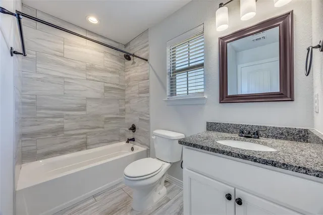 an empty room with window and ceiling fan