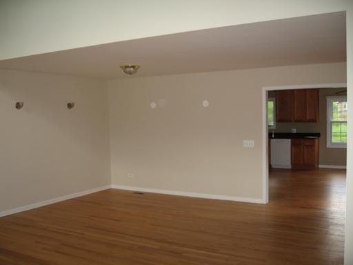 3929 Maple Avenue Northbrook, IL 60062 - Photo 4 of 16 a view of empty room with wooden floor and kitchen