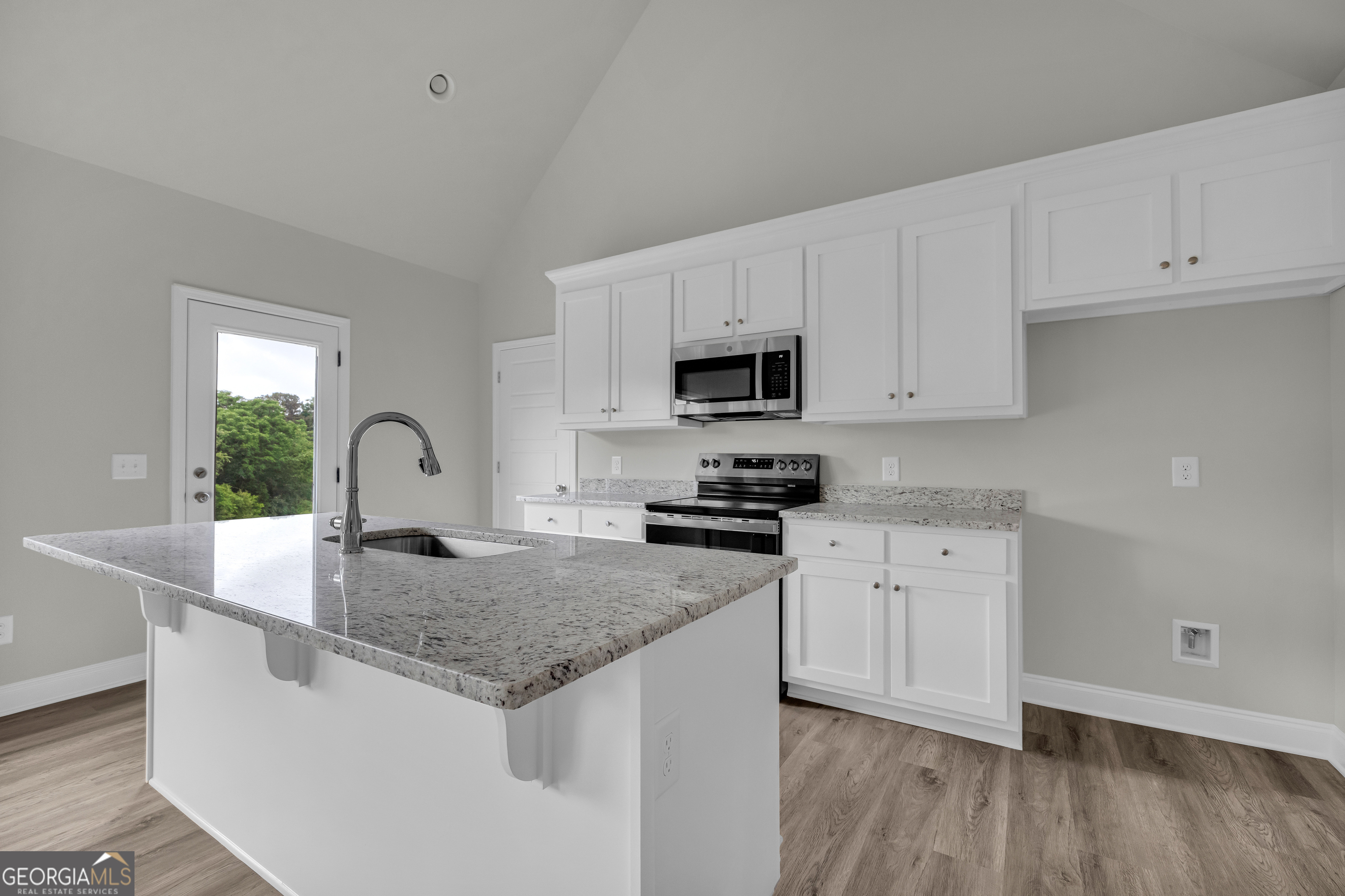 110 Sewell Road Lavonia, GA 30553 - Photo 33 of 73 a kitchen with sink a microwave and cabinets