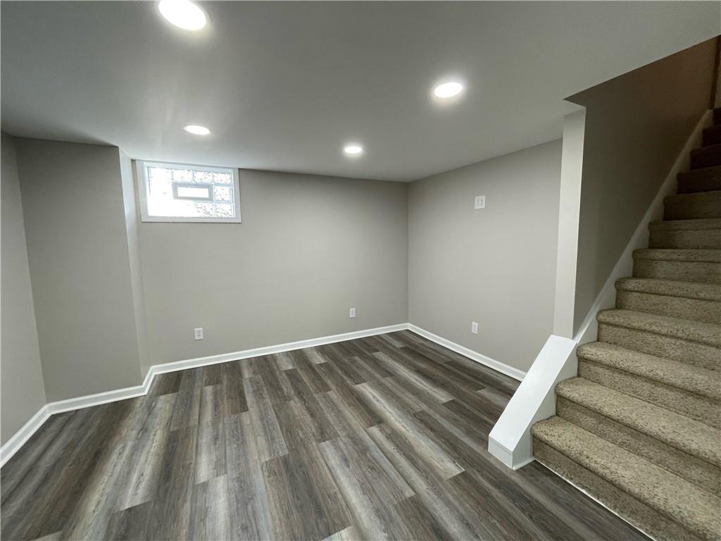 115 Bell Court Road McKees Rocks, PA 15136 - Photo 15 of 19 an empty room with wooden floor and staircase