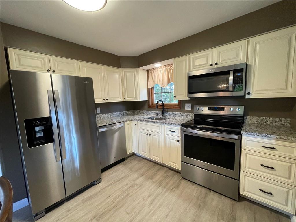 115 Bell Court Road McKees Rocks, PA 15136 - Photo 8 of 19 a kitchen with stainless steel appliances a refrigerator stove and microwave