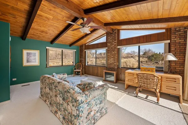 a bedroom with furniture and large window