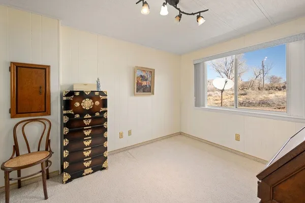 a room with a window and dresser