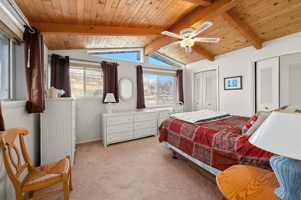 a bed room with a bed and a chair