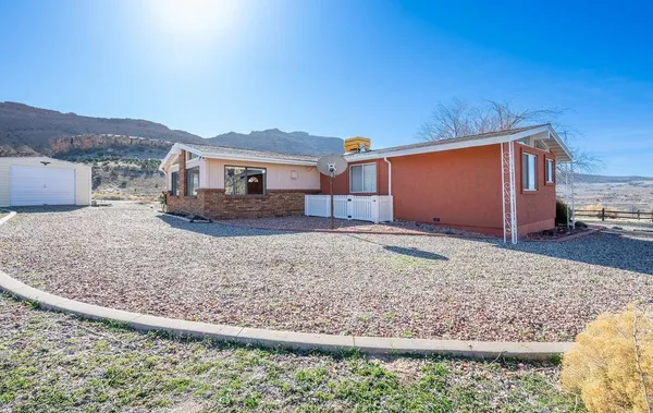 a view of a house with a backyard