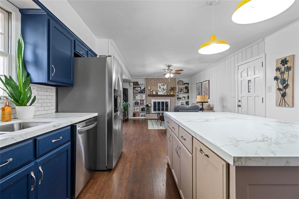 1436 Willivee Drive Decatur, GA 30033 - Photo 9 of 49 a kitchen with stainless steel appliances granite countertop a sink a stove and a wooden floors