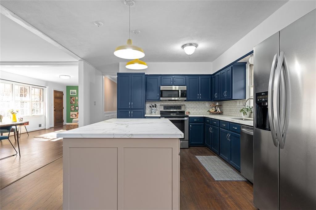 1436 Willivee Drive Decatur, GA 30033 - Photo 10 of 49 a kitchen with stainless steel appliances granite countertop a sink stove and refrigerator
