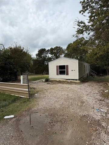 a backyard of a house with plants and trees