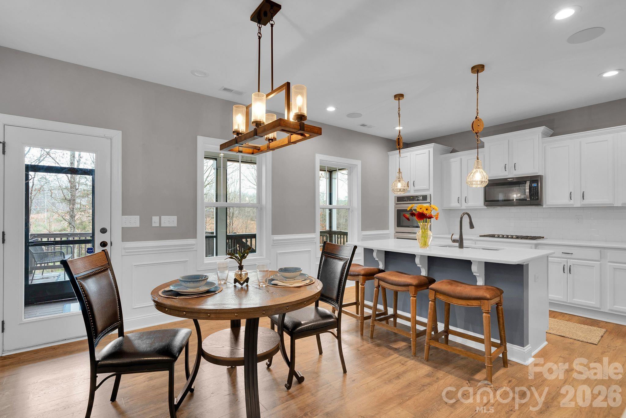 663 Highland Ridge Point Lake Wylie, SC 29710 - Photo 11 of 42 a dining room with furniture a chandelier and wooden floor