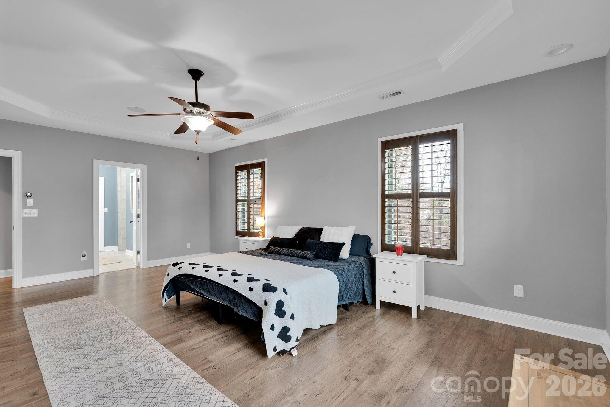 663 Highland Ridge Point Lake Wylie, SC 29710 - Photo 14 of 42 a bedroom with a bed chandelier and a window