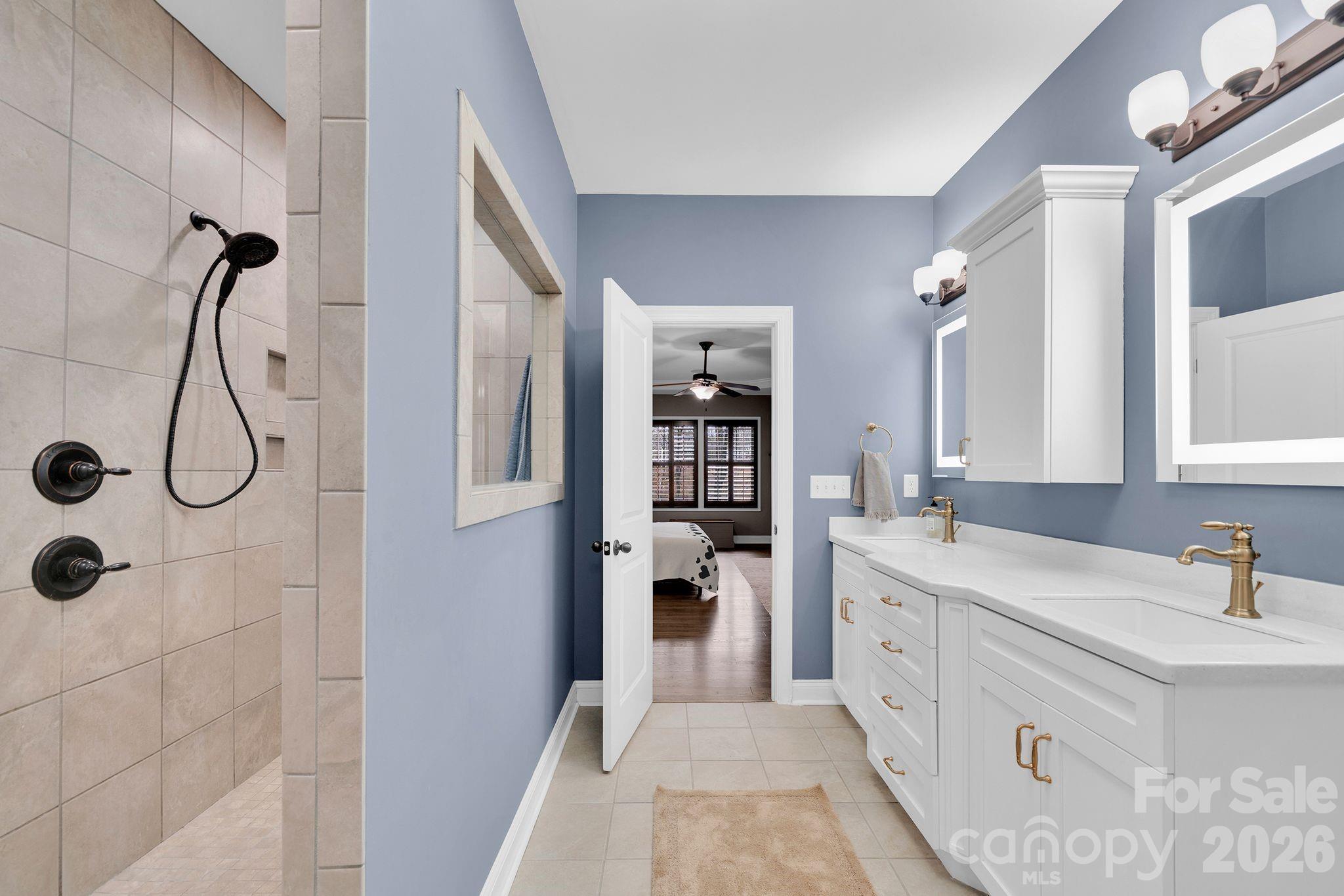 663 Highland Ridge Point Lake Wylie, SC 29710 - Photo 15 of 42 a bathroom with a double vanity sink toilet and shower