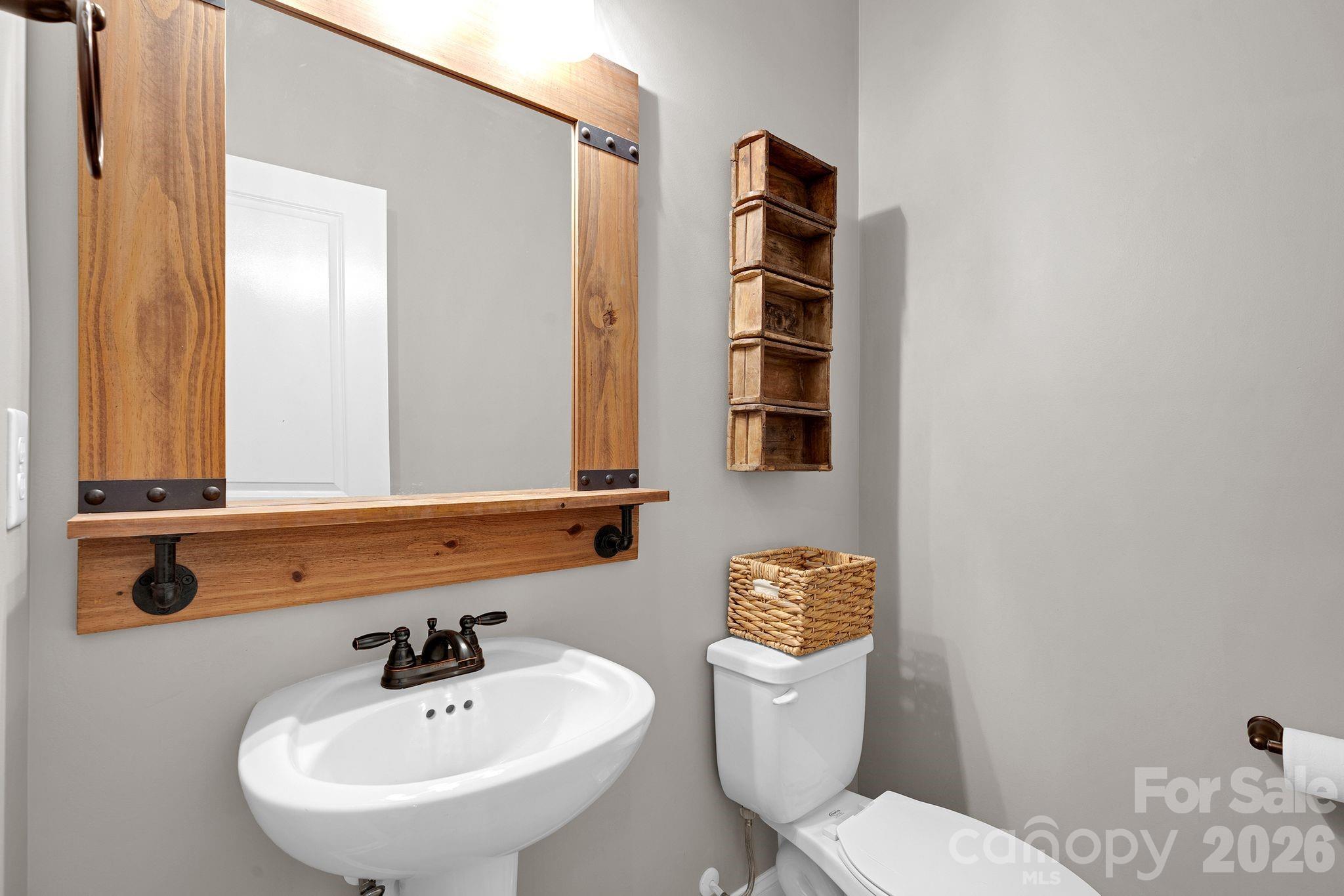 663 Highland Ridge Point Lake Wylie, SC 29710 - Photo 18 of 42 a bathroom with a toilet a sink and mirror