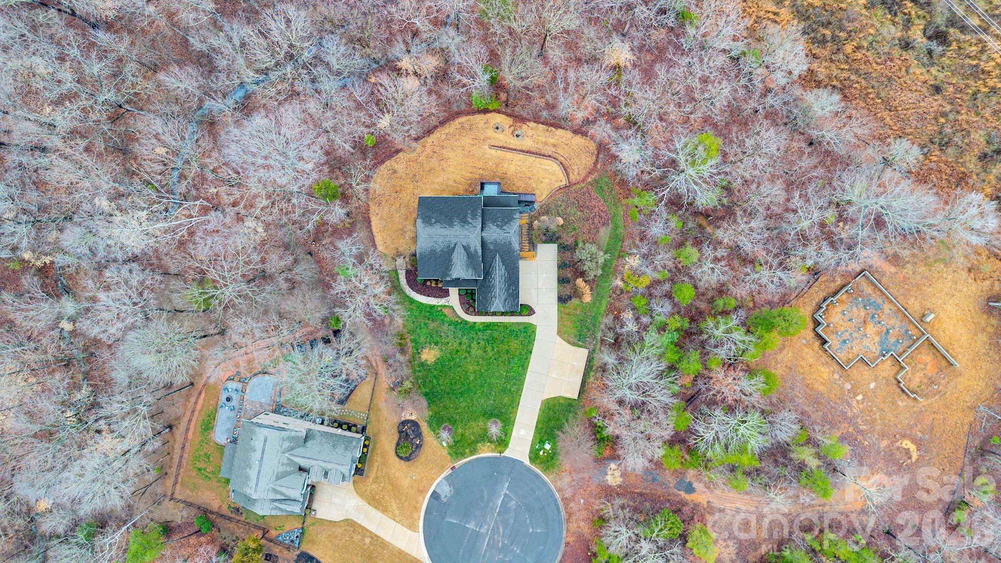 663 Highland Ridge Point Lake Wylie, SC 29710 - Photo 2 of 42 a aerial view of a house with a yard and large tree