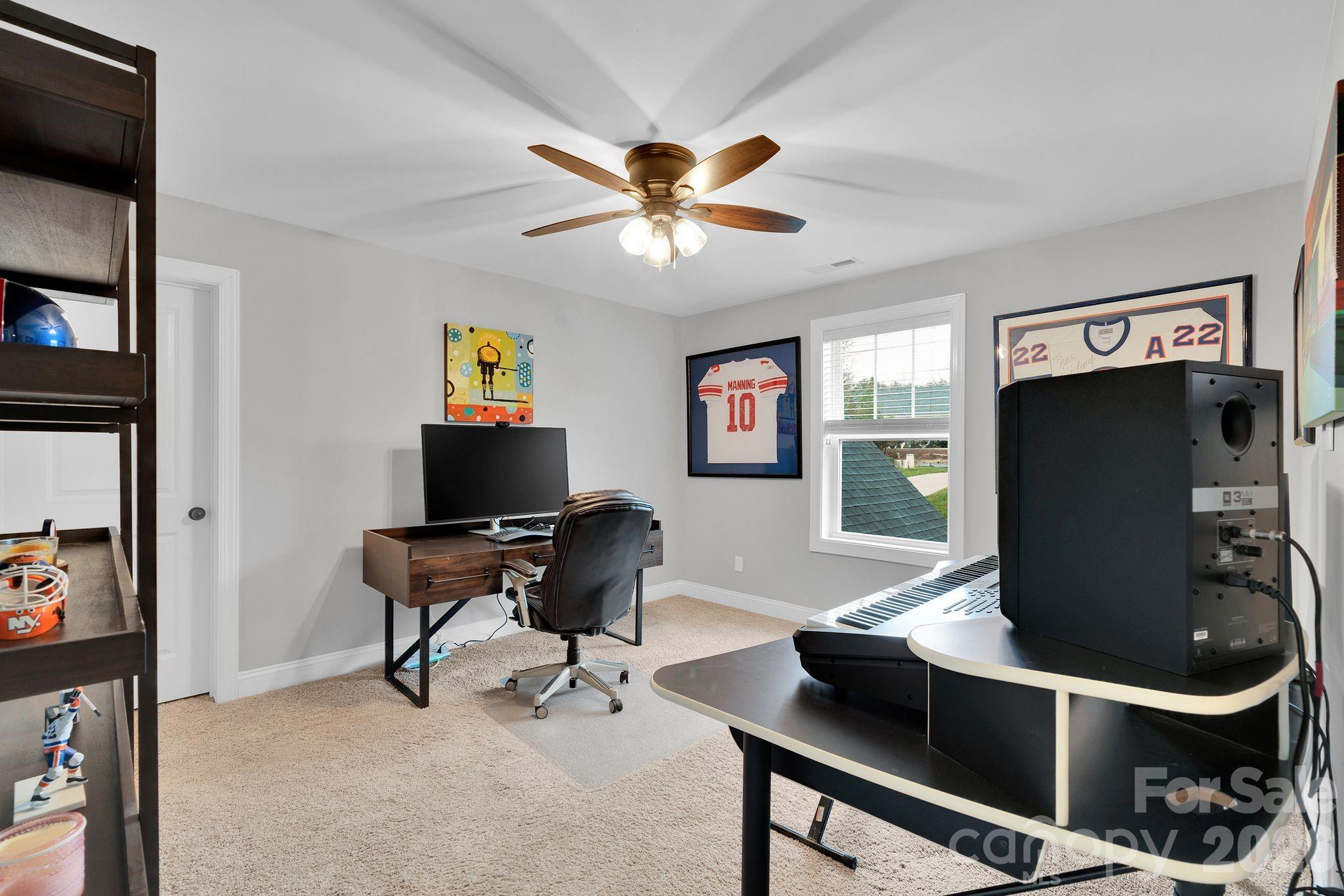 663 Highland Ridge Point Lake Wylie, SC 29710 - Photo 28 of 42 a work room with furniture and a flat screen tv