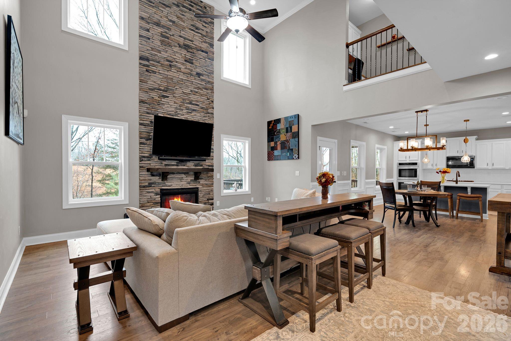 663 Highland Ridge Point Lake Wylie, SC 29710 - Photo 6 of 42 a living room with furniture a fireplace and a flat screen tv