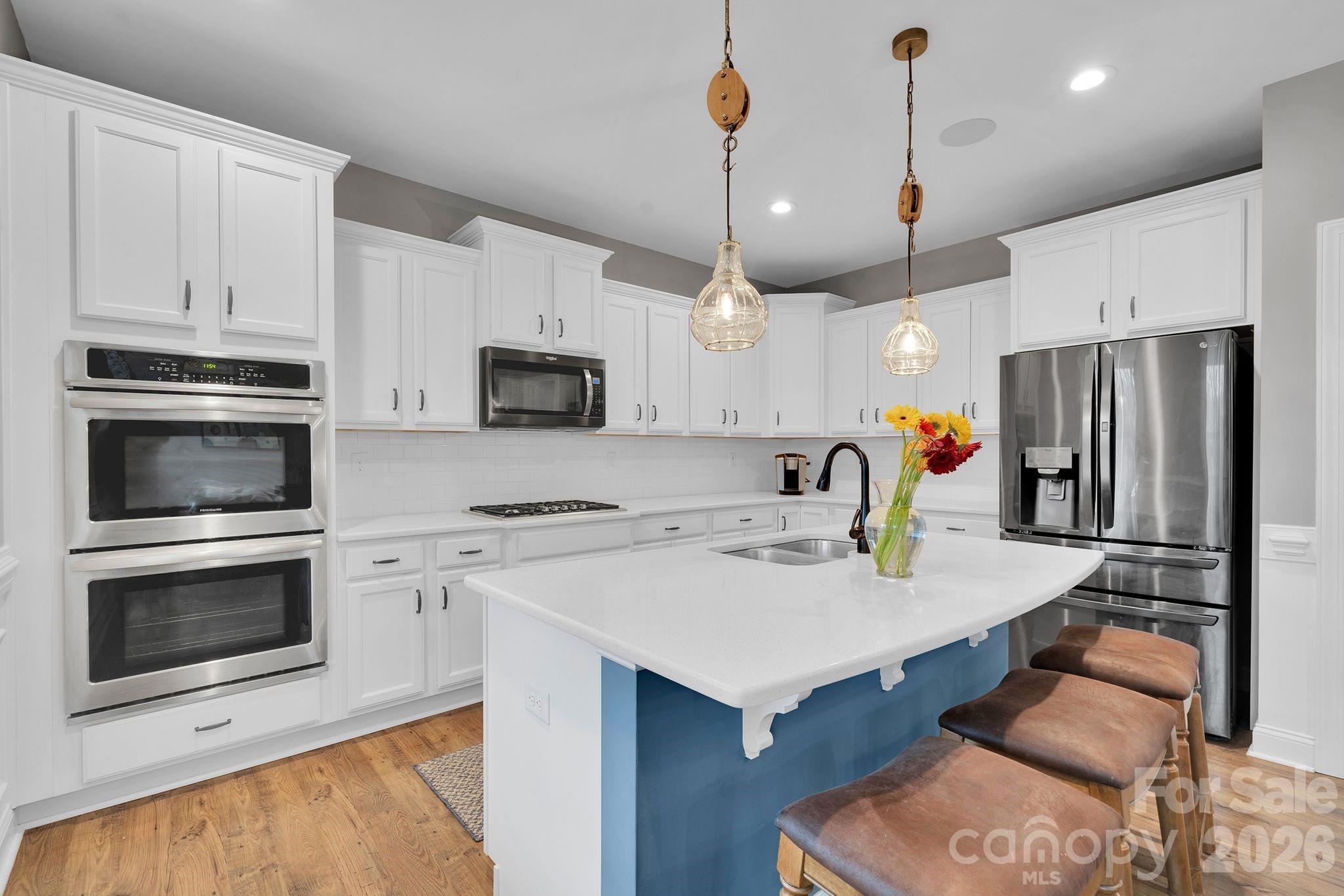 663 Highland Ridge Point Lake Wylie, SC 29710 - Photo 9 of 42 a kitchen with a refrigerator a stove a microwave oven a sink and cabinets