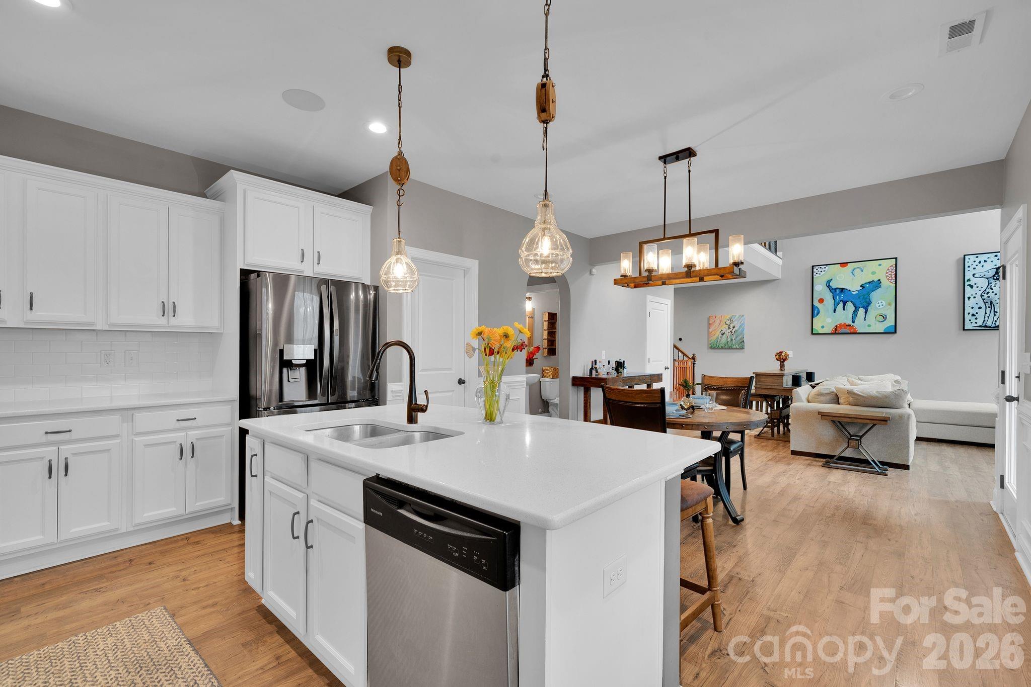 663 Highland Ridge Point Lake Wylie, SC 29710 - Photo 10 of 42 a view of kitchen center island dining table wooden floor and living room view