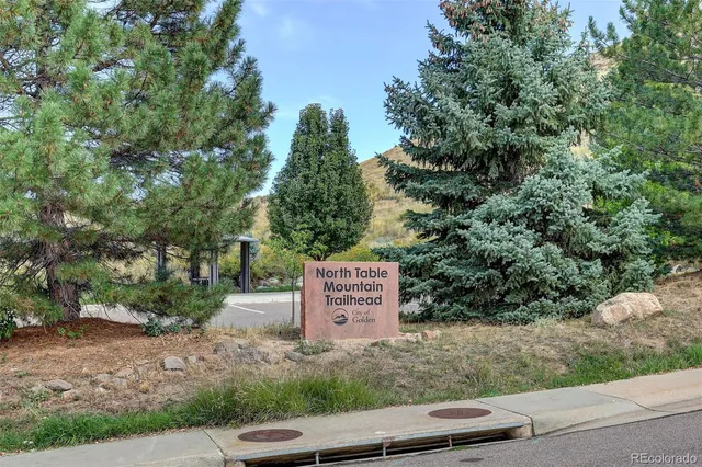 a view of a patio with a table and chairs under an umbrella
