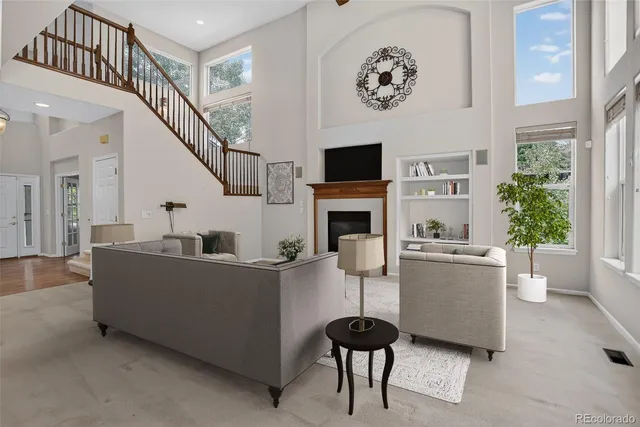 a living room with furniture and a fireplace