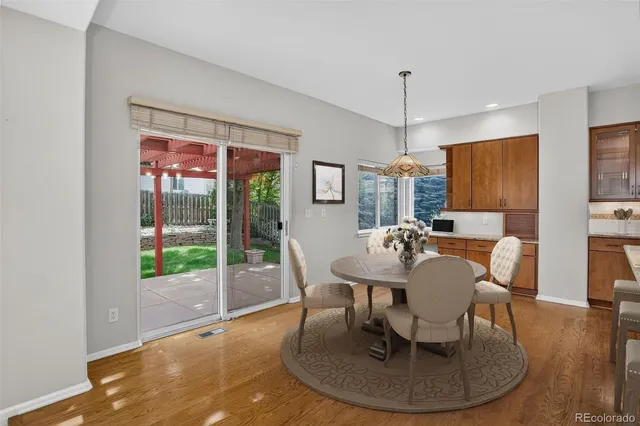 a dining room with furniture a chandelier and wooden floor