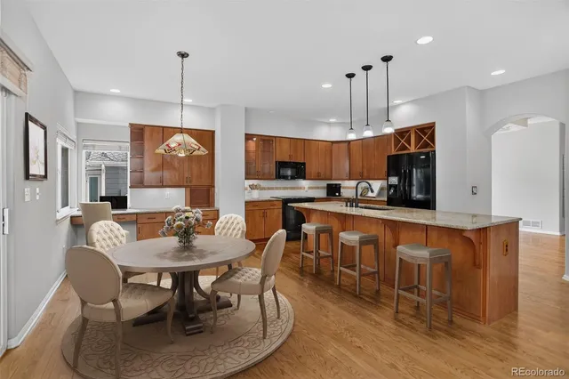 a large kitchen with a table and chairs