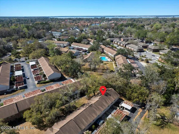 a room with pool table and windows