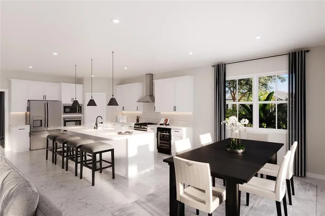 a kitchen with stainless steel appliances kitchen island granite countertop a stove a refrigerator a sink a dining table and chairs with wooden floor