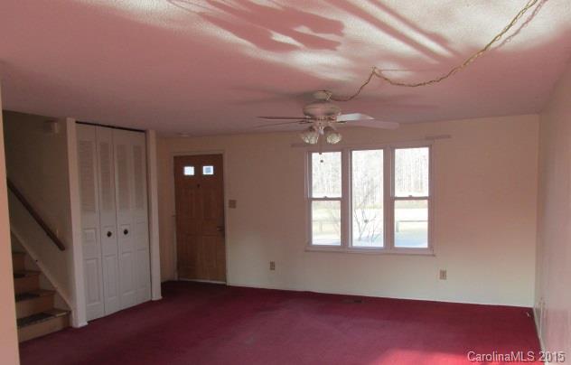 4720 Cheviot Road Charlotte, NC 28269 - Photo 5 of 15 an empty room with windows and chandelier fan