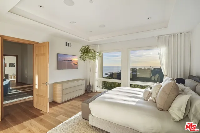 a bed room with a bed mirror and a table