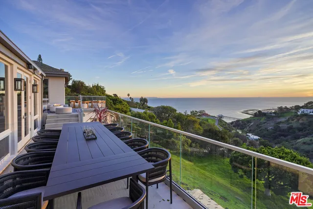 an aerial view of a residential houses with outdoor space and street view