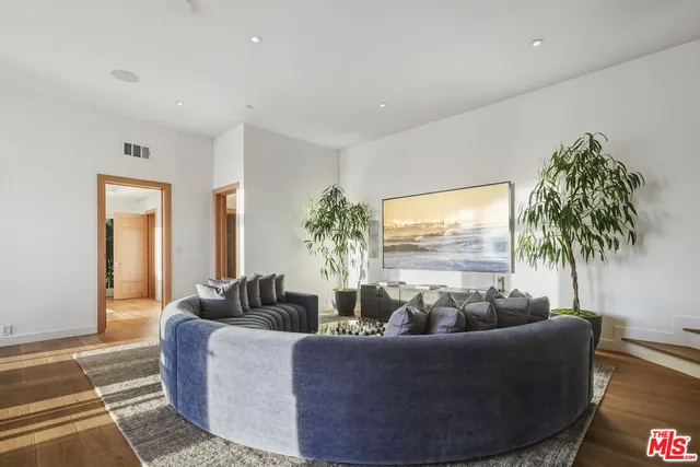 a living room with furniture and a floor to ceiling window