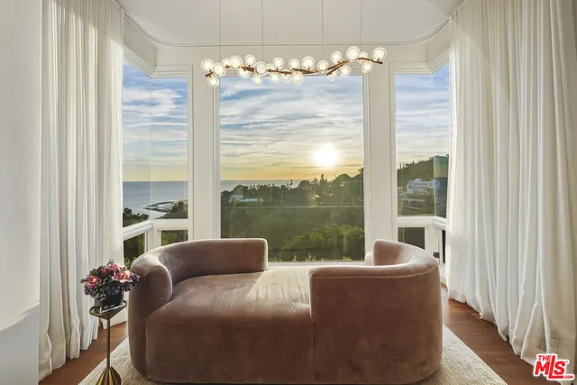 a living room with patio furniture and a flat screen tv