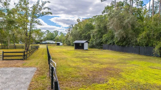 a view of swimming pool with sitting area and garden