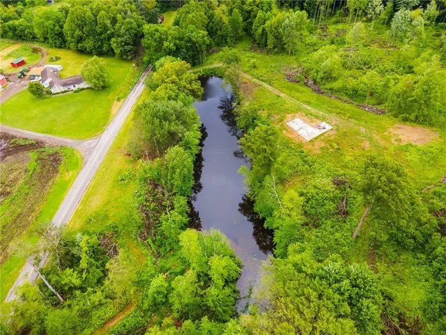 an aerial view of residential houses with outdoor space and street view
