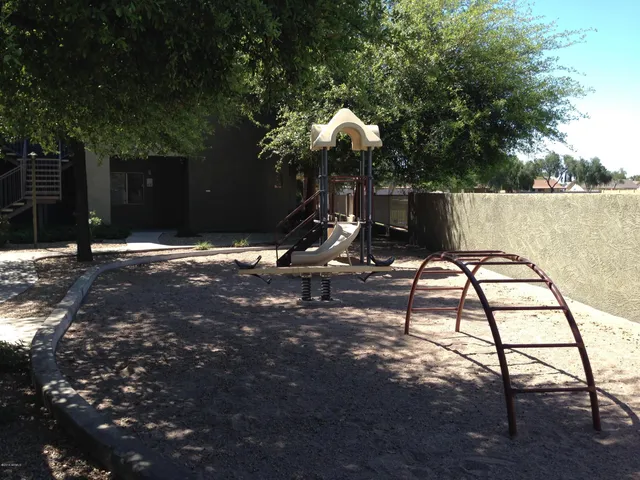 a backyard of a house with table and chairs