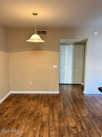 an empty room with wooden floor