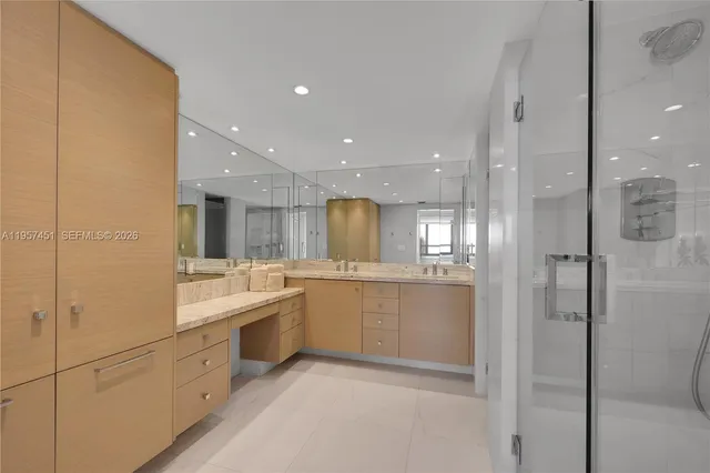 a large bathroom with a large mirror vanity and shower