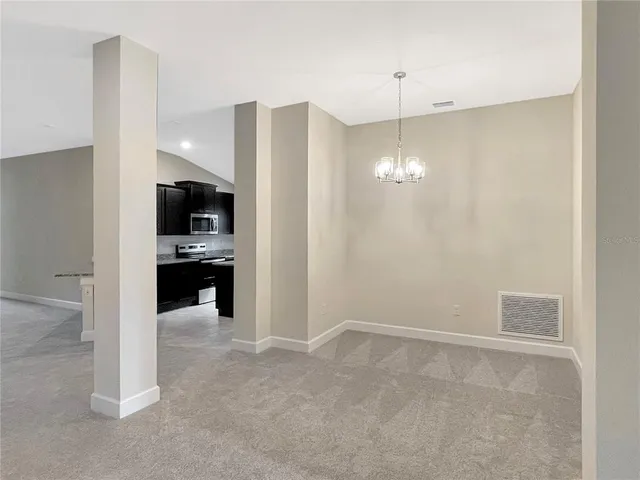 a kitchen view with stainless steel appliances a refrigerator and a counter top space