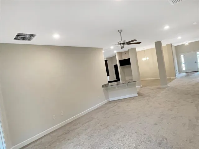 an empty room with a ceiling fan